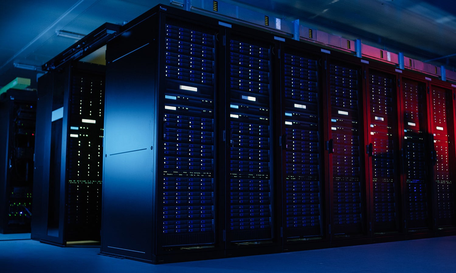 A bank of servers lit in white, purple, blue and red.